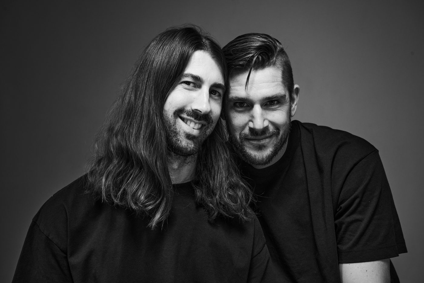Black and white portrait, black tees, heads together