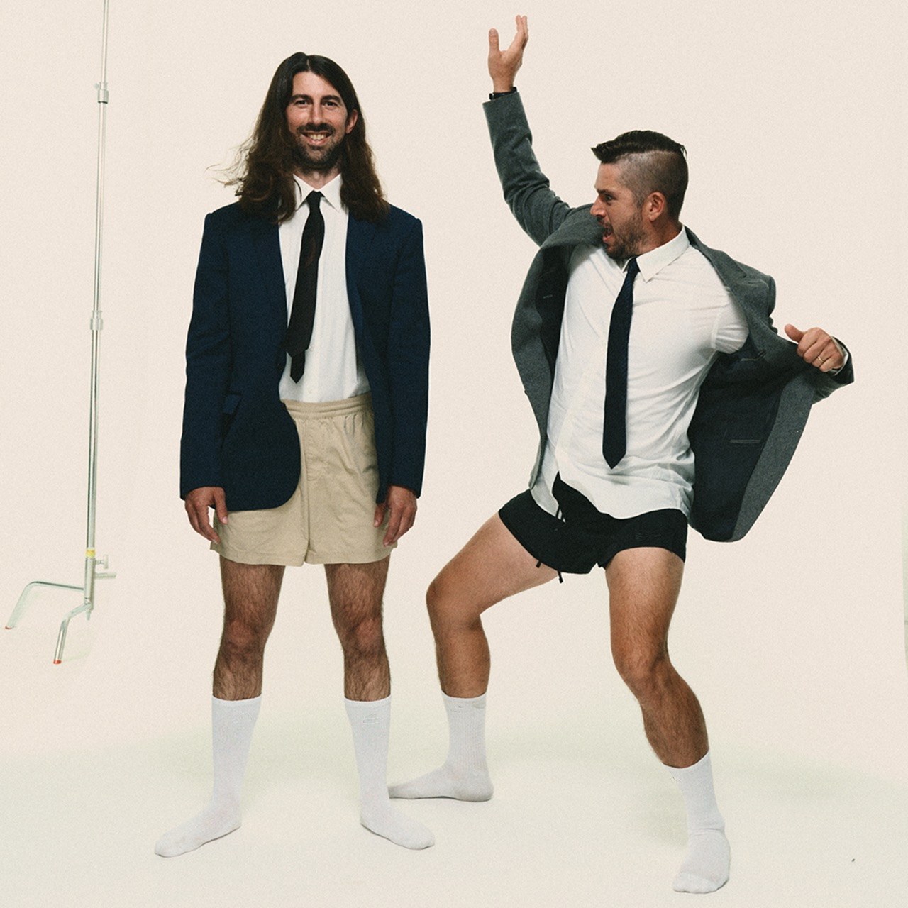 Deal Me In — single cover: blazers, shorts, tube socks, one mid-kick on white seamless