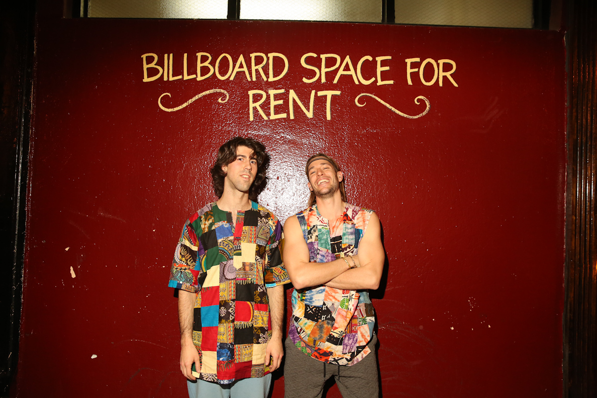 Pat and Sam in front of BILLBOARD SPACE FOR RENT